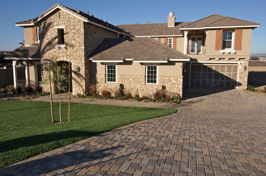 A newly constructed, modern american home with fresh landscaping