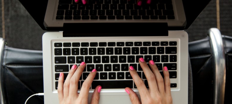 Person typing on laptop keyboard